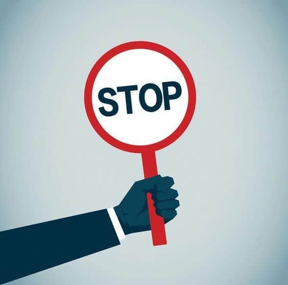 Hand holding a stop sign